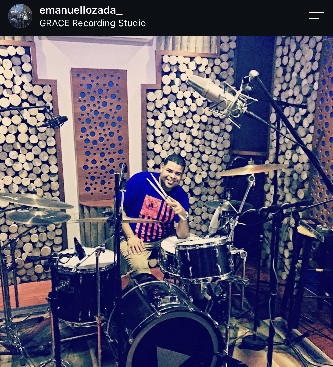 Emanuel Lozada seated behind a miked drum kit at Grace Recording Studio in Puerto Rico